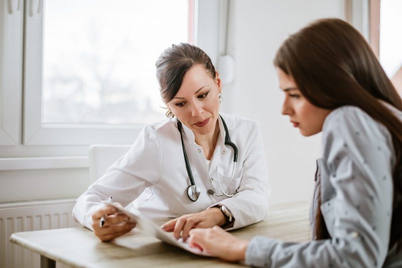 Image of a physician using a brochure to advise a patient