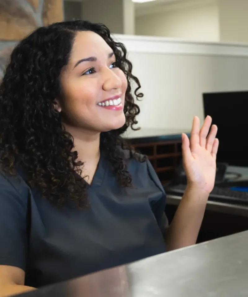 Woman waving to get attention.